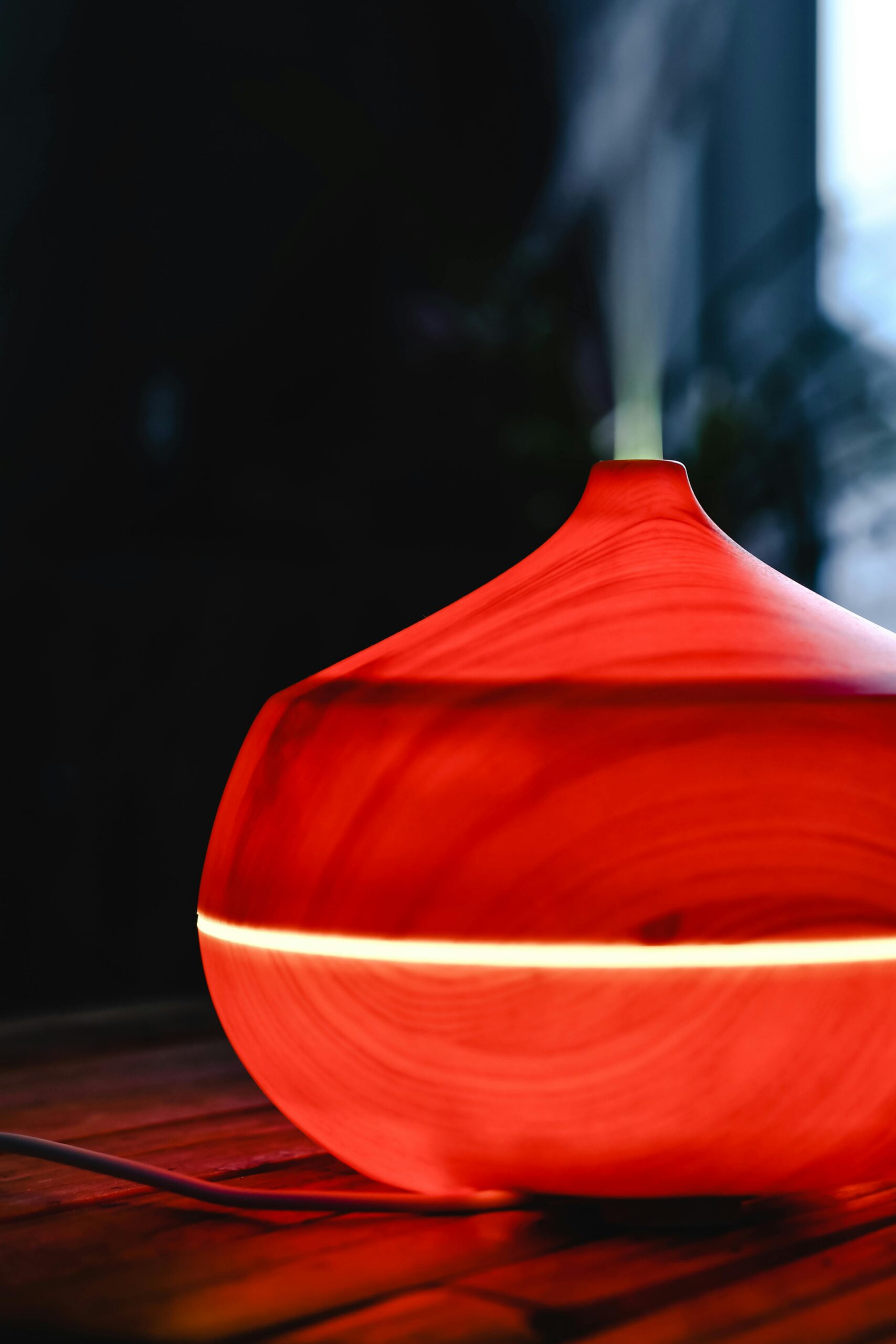 Stylish red wooden diffuser emitting gentle steam, perfect for aromatherapy enthusiasts.